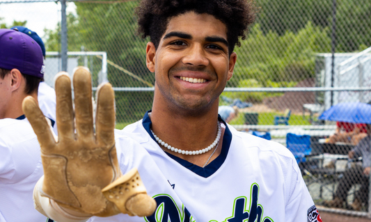College baseball player showing a Launchpad thumb guard on his hand