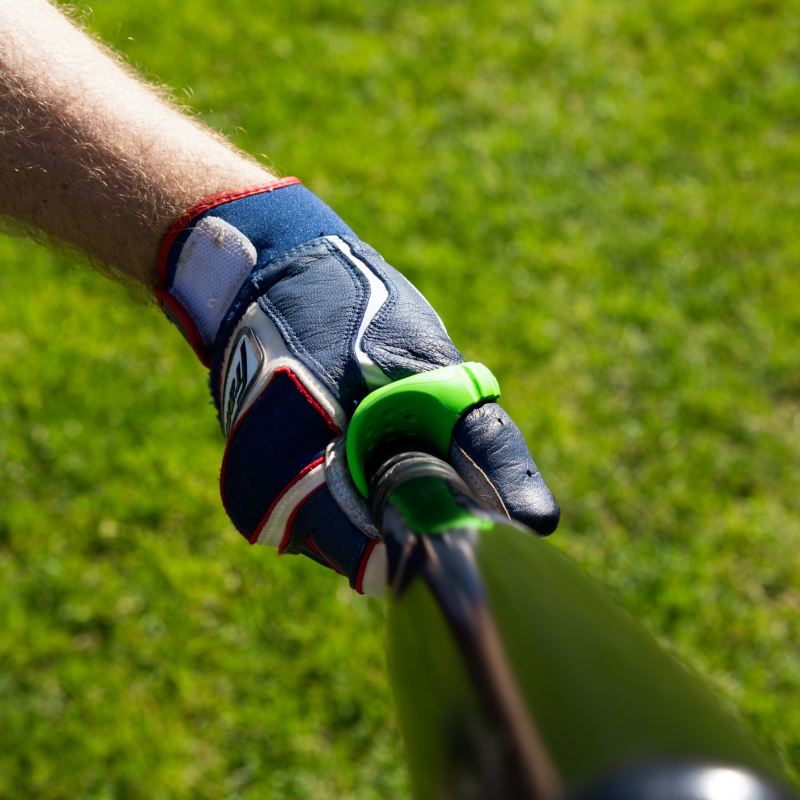 Hand with baseball glove holding a bat in the Launchpad bat channel