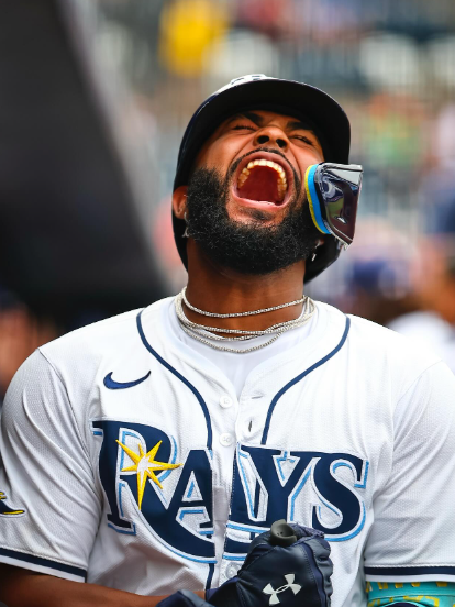 Baseball player yells in excitement with clenched fists