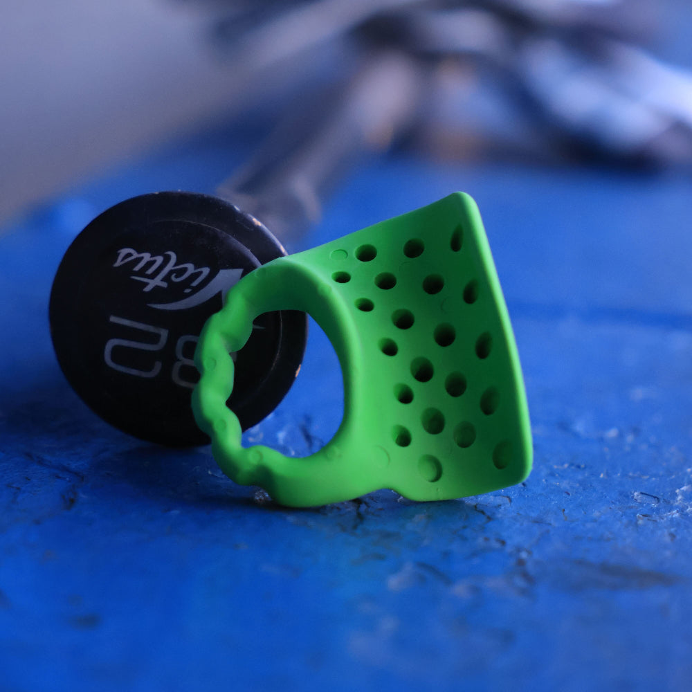 Green baseball thumb guard sitting on a blue bench
