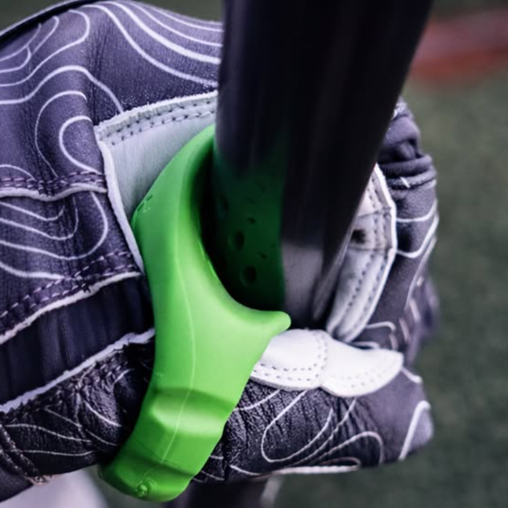 Bat seated in the Launchpad thumb guard's patented bat-shaped channel in a hitter's top hand