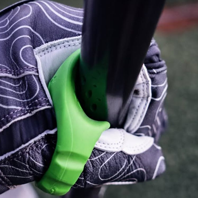 Close-up of a green baseball thumb guard gripping a bat handle